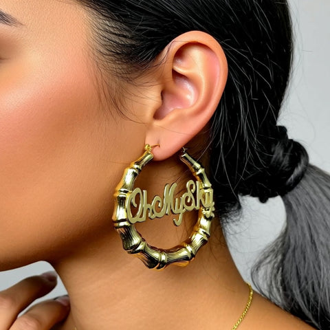 Large Bamboo Name Earrings 2 inch on a person
